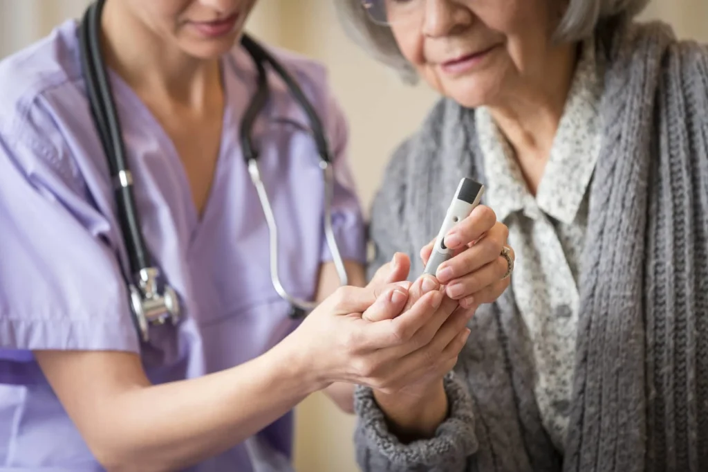 a doctor tests the elderly woman's blood sugar